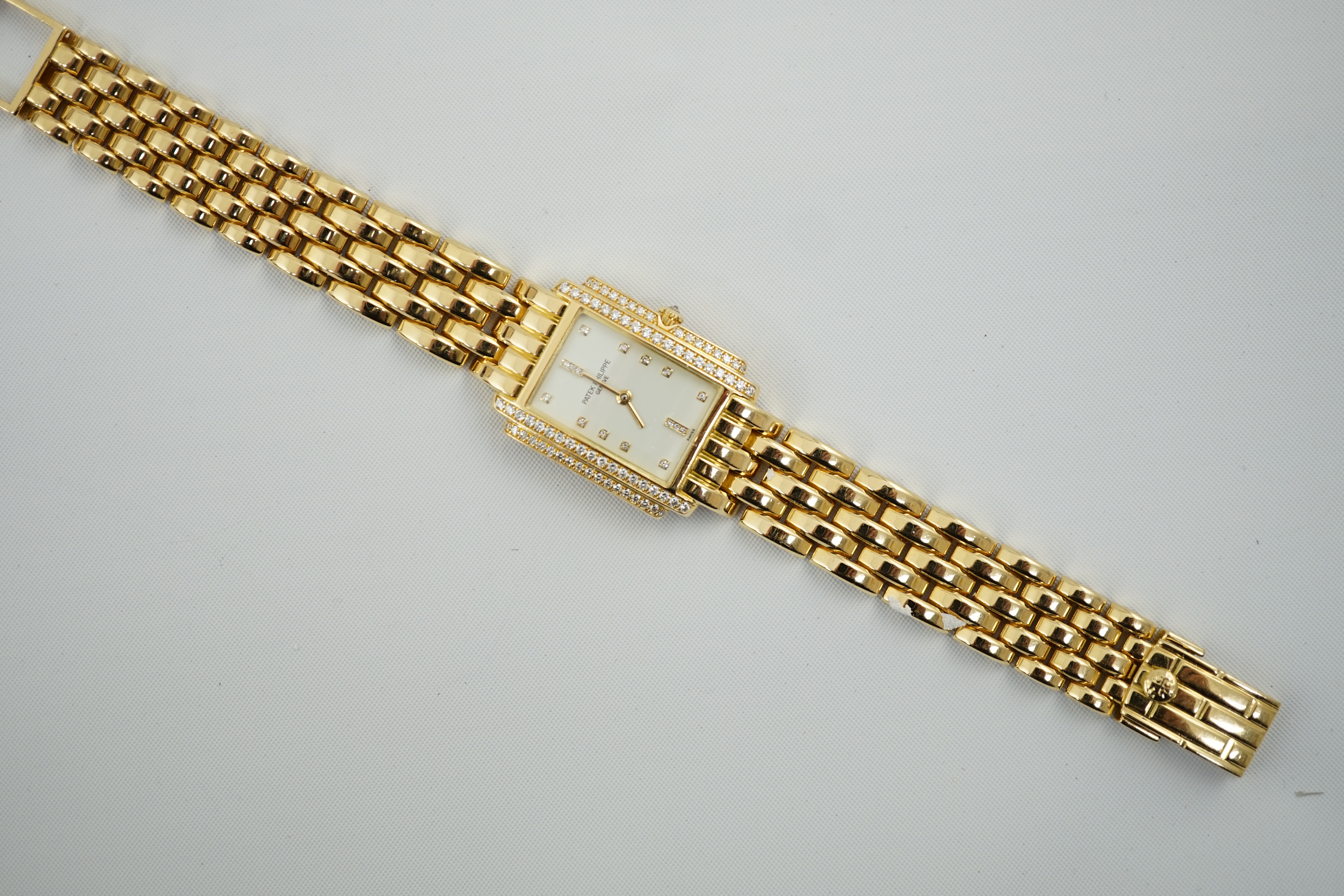 A lady's late 1990's 18ct gold and diamond set Patek Philippe Gondolo quartz wrist watch, on an 18ct gold Patek Philippe bracelet